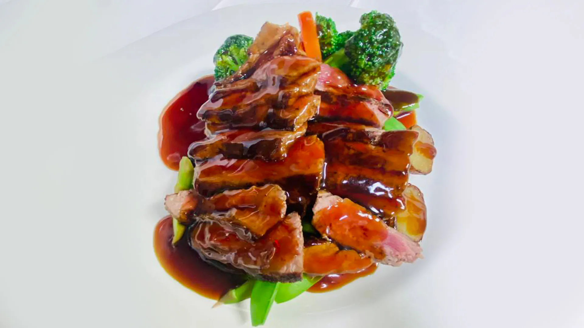 Grilled teriyaki steak with broccoli and carrots at Musashi & Mizu Sushi, an Asian Fusion Restaurant in Brooklyn