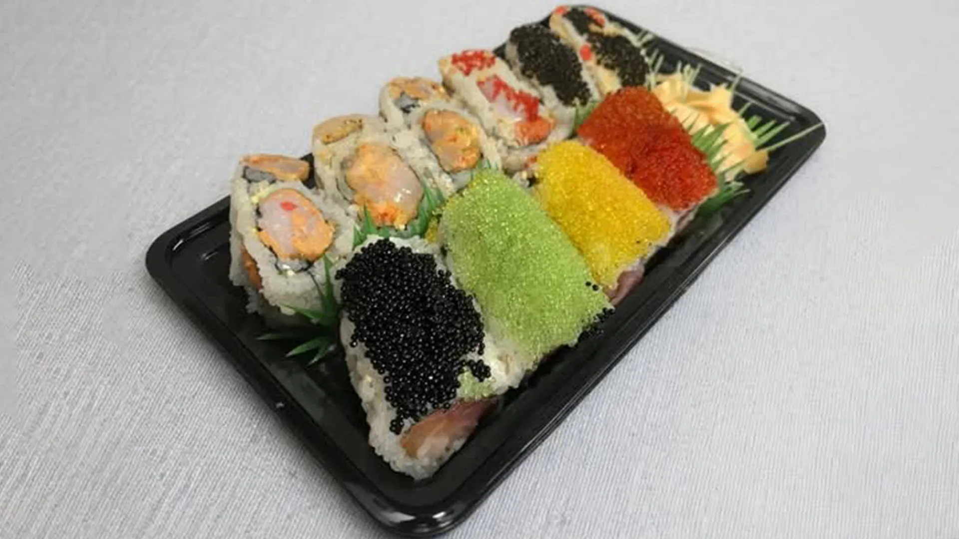 Colorful sushi rolls with tobiko toppings at Musashi & Mizu Sushi, an Asian Fusion Restaurant in Brooklyn